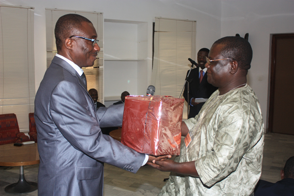 Mr Albert Bah (former Research Officer), receiving his gift from Mr. Dakitse-Benissan, Research Officer of the AACB’s Executive Secretariat